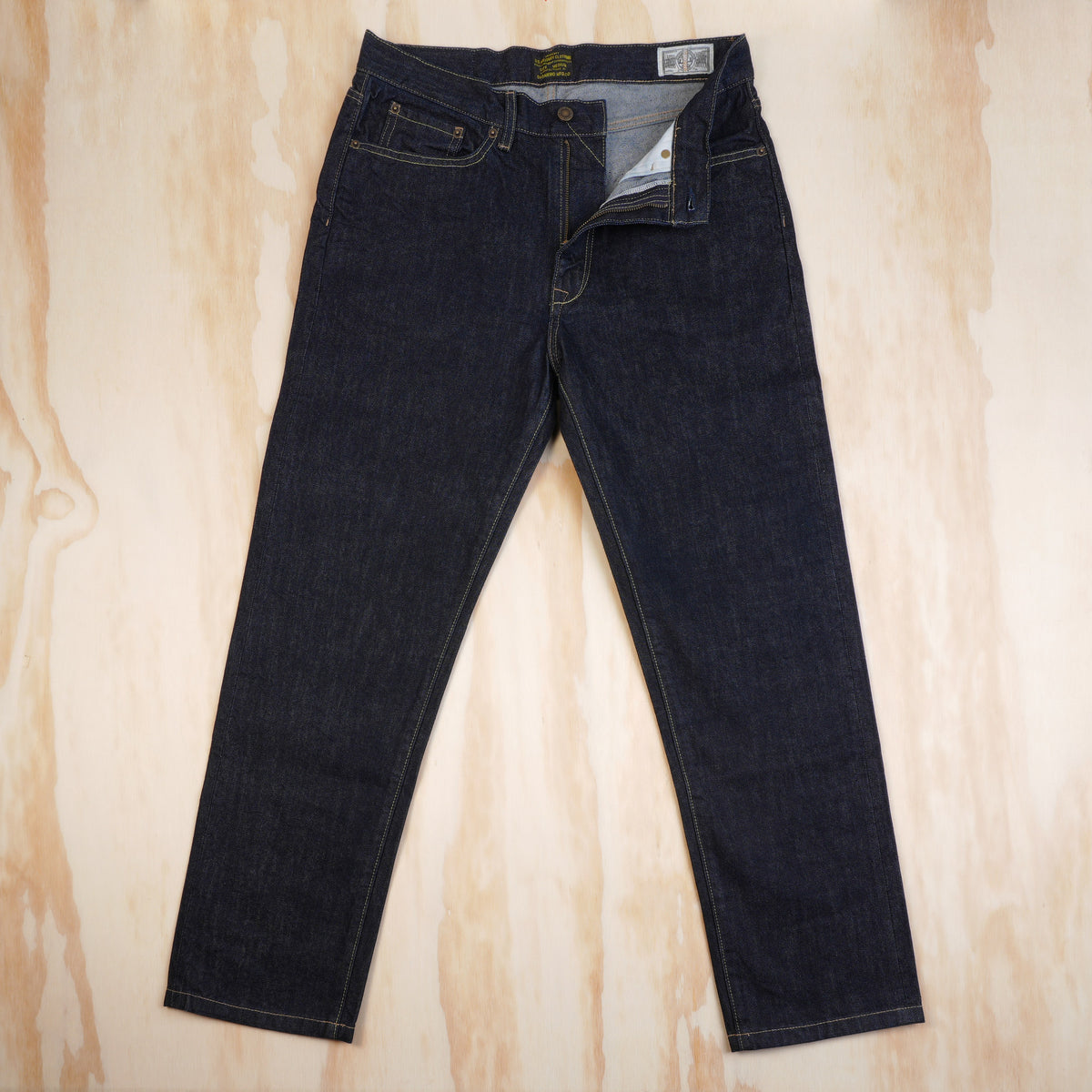 OKONKWO selvedge jeans with the zip fly open and waistband details visible